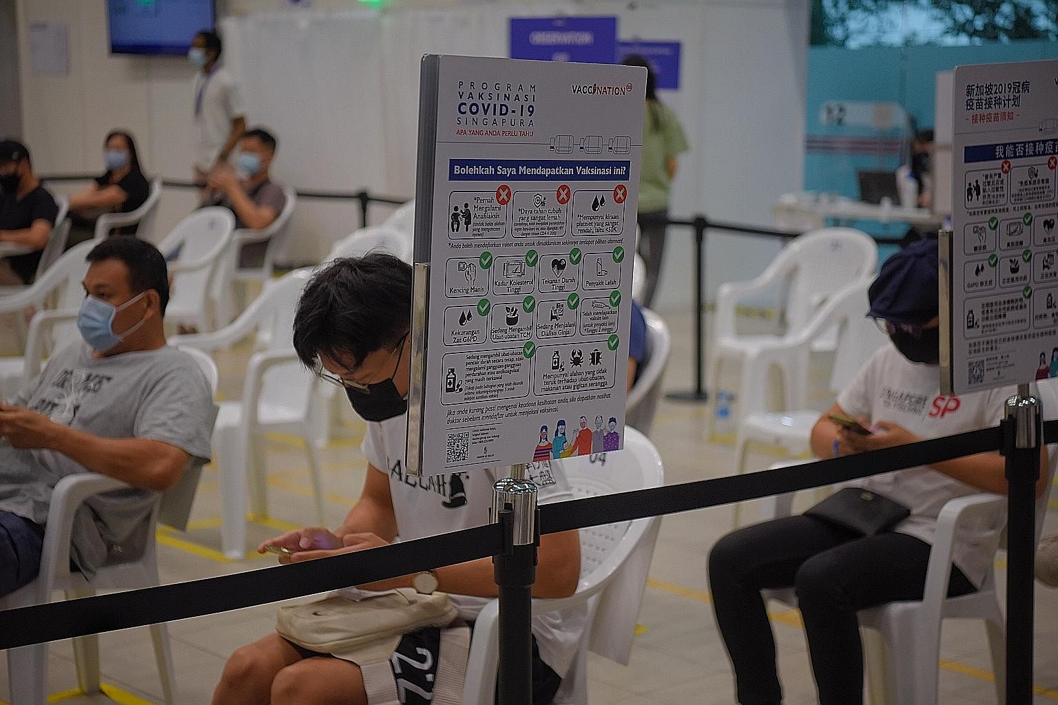 People waiting in the observation area at the Covid-19 vaccination centre at Yew Tee Community Club last week, after receiving their jabs. Slightly more than one-third of the population in Singapore have been given at least one dose of a Covid-19 vac