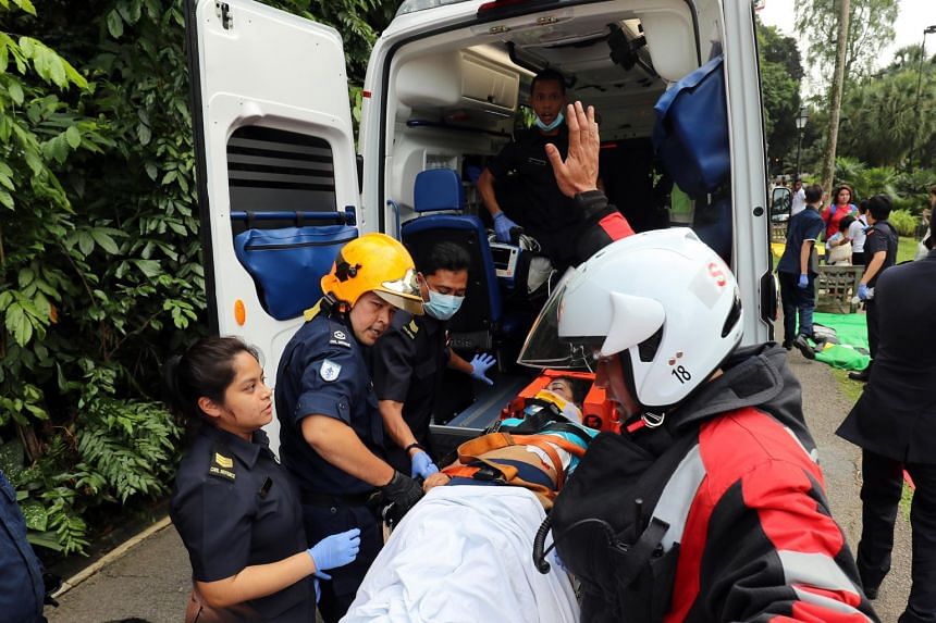 Members of the SCDF attending to injured people after the collapse of the Tembusu tree on Feb 11, 2017. 