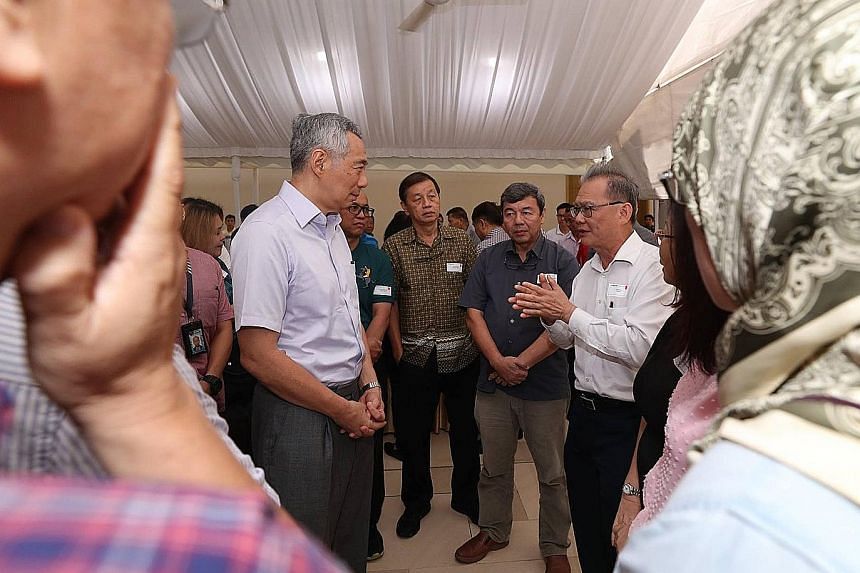 Prime Minister Lee Hsien Loong speaking to attendees of a closed-door post-National Day Rally dialogue organised by the People's Association on Oct 14, at a reception after the event.