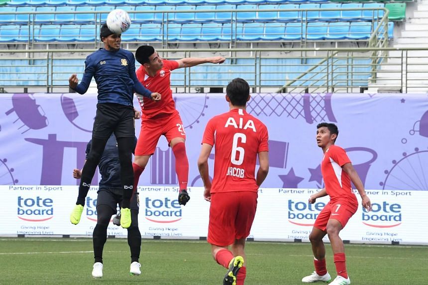 In this photo taken on March 31, national striker Fazrul Nawaz (in blue) engages in an aerial duel with Young Lions defender Lionel Tan during the match between Hougang United and the Young Lions.