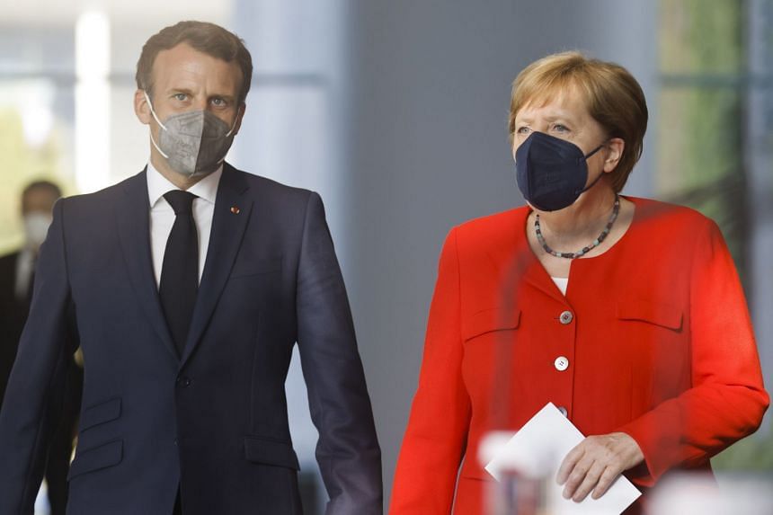French President Emmanuel Macron (left) and German Chancellor Angela Merkel arrive to give a news statement in Berlin.