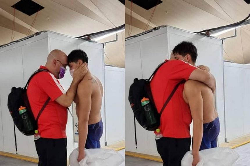 Joseph Schooling sharing a warm embrace with his swim coach, Sergio Lopez, at the Tokyo Aquatics Centre.