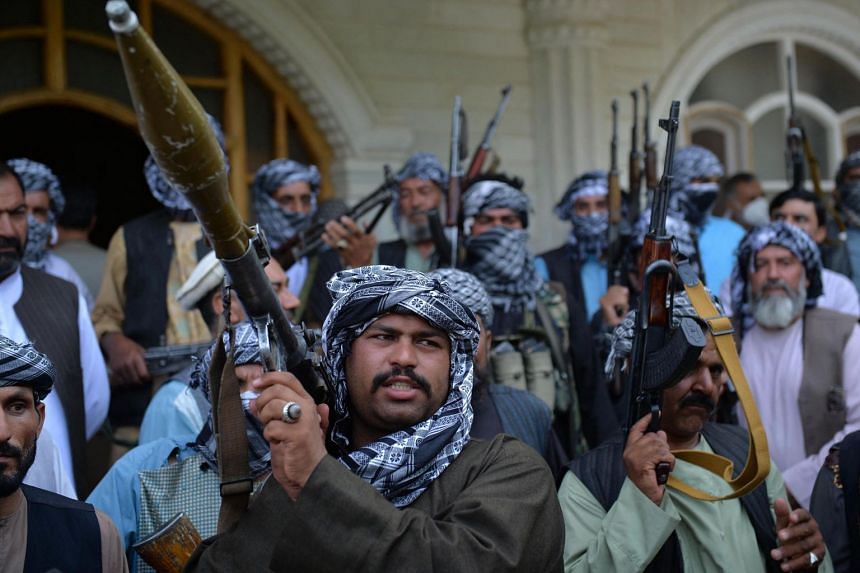 Afghan militia gather with their weapons to support Afghanistan security forces against the Taleban, in Herat on July 9, 2021. 