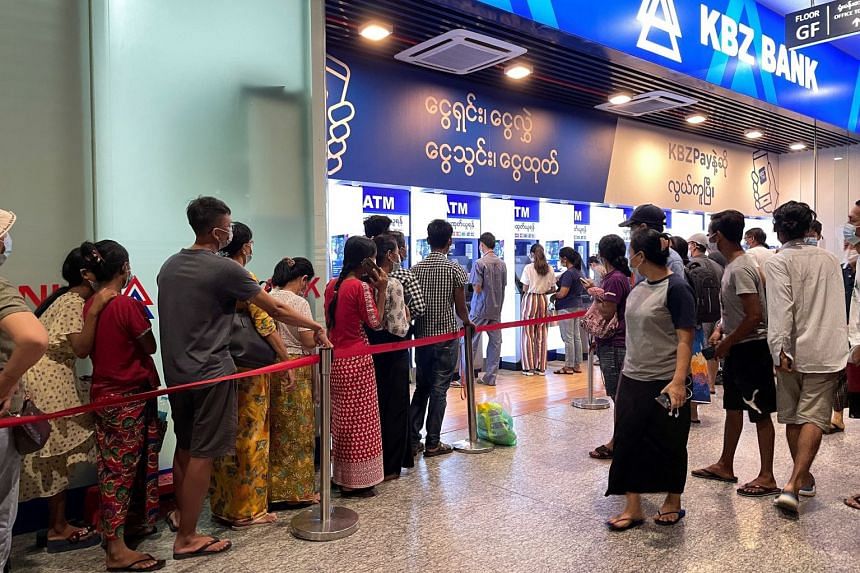 People line up in front of ATMs to withdraw cash, in Yangon, Myanmar, in May 2021.