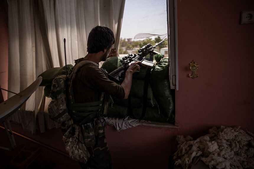 An Afghan commando at a frontline position in a civilian house in Kunduz on July 6, 2021.