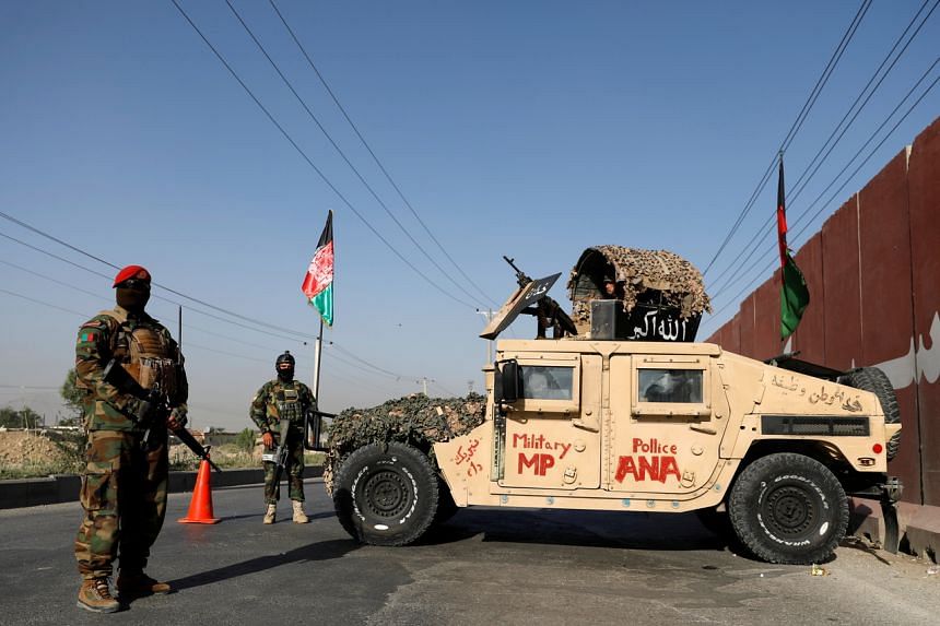 Afghan National Army officers keep watch at a checkpoint in Kabul, on July 8, 2021.