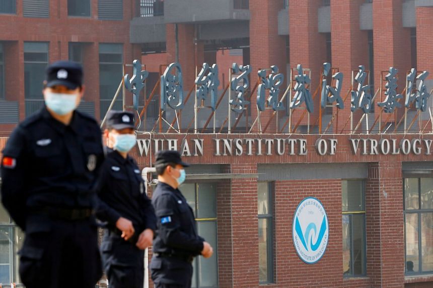 Security personnel keep watch outside the Wuhan Institute of Virology, during a visit by a WHO team tasked with investigating the origins of coronavirus, in February 2021.