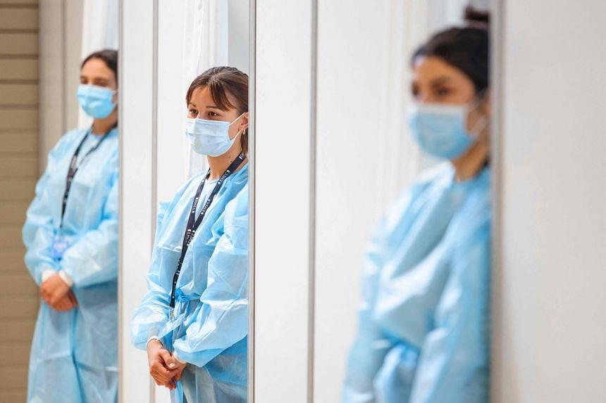 Healthcare workers at a vaccination centre in Lausanne. Switzerland's vaccine deliveries are conducted by the Swiss army.