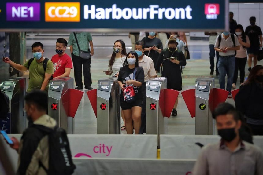 A photo from Aug 4, 2021, shows commuters at HarbourFront MRT station.