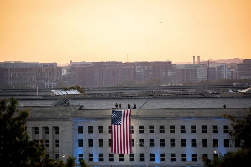 The American flag is unfurled at the site where a hijacked plane crashed into the Pentagon 20 years ago, on Sept 11, 2021.