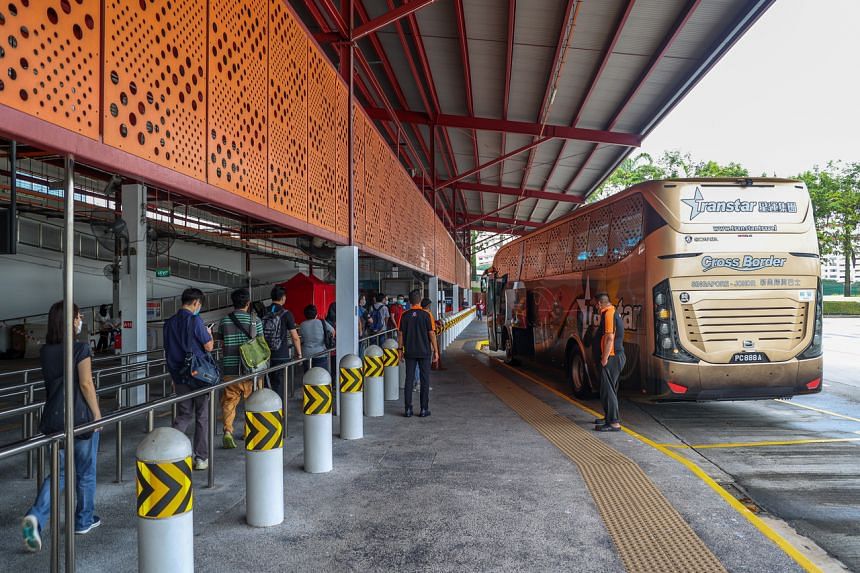 People boarding a bus as part of a VTL simulation exercise at Woodlands Temporary Bus Interchange on Nov 23, 2021.