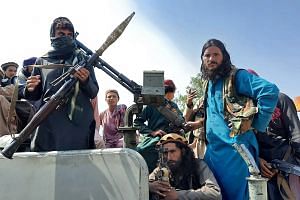 Taliban fighters on a street in Laghman province, Afghanistan, on Aug 15, 2021.