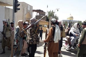 Taleban militants patrol after taking control of the Governor's house and Ghazni city on Aug 12, 2021.