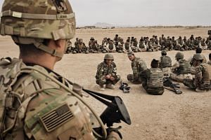 American soldiers overseeing training of their Afghan counterparts at Camp Bastion in Helmand Province, Afghanistan on March 22, 2016.