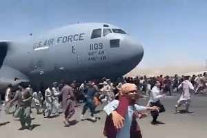 Crowds of people were seen attempting to climb up an US Air Force plane at Kabul airport, on Aug 16, 2021.