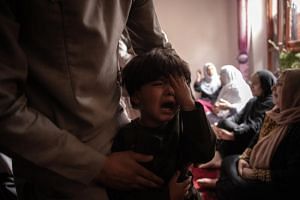 A boy cries in Kabul on  Aug 30, 2021, over the death of his sister in a US drone strike.