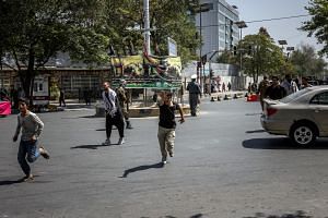 Protesters flee as Taliban forces fire their weapons into the air in Kabul, on Sept 7, 2021.