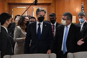 US Secretary of State Antony Blinken (centre) and Malaysian Foreign Minister Saifuddin Abdullah (right) arrive for a meeting in Putrajaya on Dec 15, 2021.