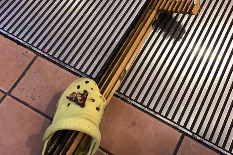 escalator pierces kid's shoe at AMK Hub 