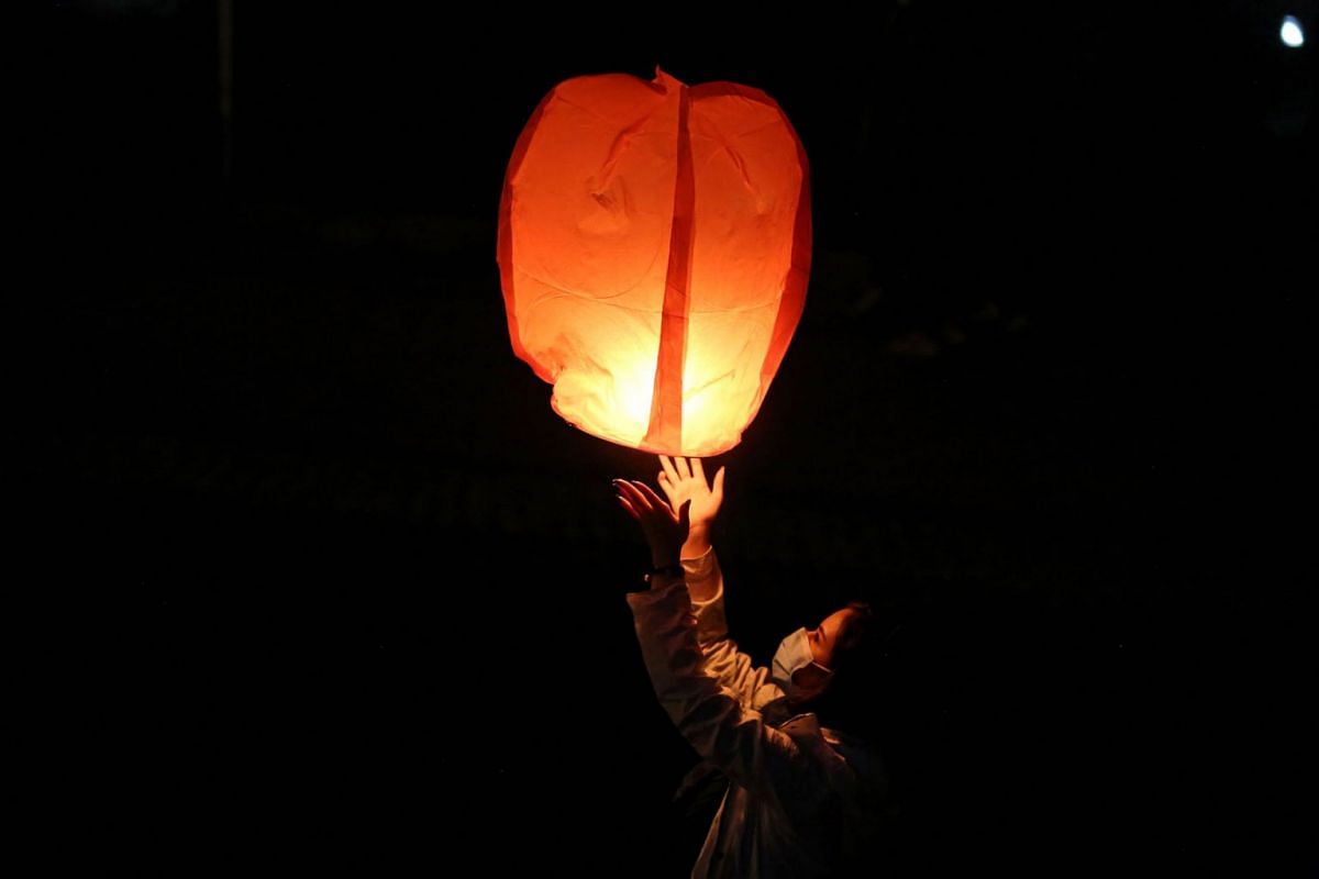 An Iranian releases a lantern in Tehran on March 16, 2021, during the Wednesday Fire feast, or Chaharshanbeh Soori, held annually on the last Wednesday eve before the Spring holiday of Noruz.